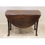 A mid 18th century oak drop leaf dining table, on tapering legs with pad feet, 70cm H x 106cm W x