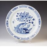 A Delft ware charger, 18th century, the tin glazed earthenware charger of circular form, the central