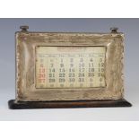 A George V silver mounted desk calendar, Birmingham 1924, the rectangular aperture displaying days
