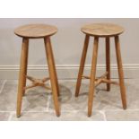 A pair of Robin Nance elm bar stools, each with a gently dished seat upon cylindrical legs united by