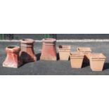 A set of four terracotta stone planters, each of tapering square form, 28cm high, along with three