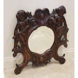 A late 19th century Italian walnut wall mirror, the oval bevelled mirrored plate within a frame