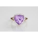 An amethyst and diamond 9ct gold cluster ring, the central triangular mixed cut amethyst measuring