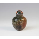 A Chinese moss agate snuff bottle, with white metal malachite and coral mounted stopper, 7cm high