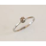 A diamond solitaire ring, comprising a central round old cut diamond, 3.5mm wide, claw set in