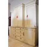 A 19th century painted pine breakfront housekeepers cupboard, the moulded cornice above four