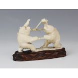 A Japanese carved ivory okimono, Meiji period (1868-1912), modelled as two battling monkeys, 9cm