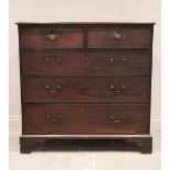 A George III mahogany chest of drawers, the rectangular moulded top above two short and three long