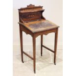 A late 19th century ladies rosewood writing desk, the raised back with a serpentine shelf and