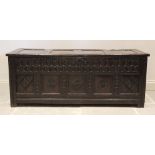 A 17th century oak coffer, the hinged cover with four invert moulded panels above a double nulled