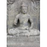 A substantial 19th century carved stone architectural figure of Guanyin, modelled in a seated