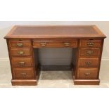 An Edwardian mahogany twin pedestal writing desk, with a rectangular leather inset skiver, above a