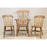 A Victorian elm and beech wood Windsor farmhouse elbow chair, the pierced splat above a shaped seat,