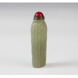 A Chinese carved jade snuff bottle, of narrow cylindrical form externally designed with stems of