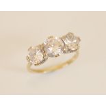 A cubic zirconia three-stone 9ct gold ring, comprising three graduated round brilliant cut cubic