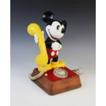 A vintage Walt Disney Mickey Mouse telephone, late 20th century, modelled as Mickey holding a yellow