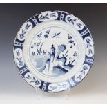 A Delft ware charger, 18th century, the tin glazed earthenware charger of circular form, the central