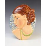 An Art Deco wall mask of large proportions, probably by Beswick, the gloss glazed mask modelled as a