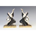 A pair of Art Deco figurines, each modelled as a scantily clad dancer set to a parcel gilt base,