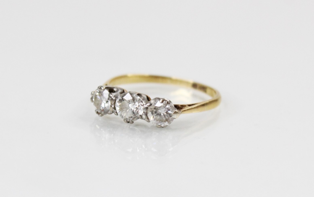 A diamond three stone ring, comprising a central round brilliant cut diamond (weighing approximately - Image 4 of 4