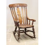 A Victorian elm and beech wood Windsor farmhouse rocking chair, the central pierced splat flanked by