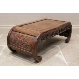 A Chinese carved wood scholars table, the rectangular panelled top extending to under swept feet