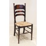 A late 19th/early 20th century Arts and Crafts stained beech wood side chair in the manner of
