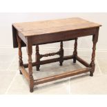 An early 18th century oak single drop leaf table, the rectangular plank top on baluster turned