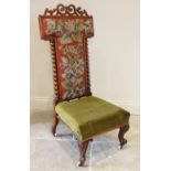 A Victorian rosewood prie dieu chair, the interlaced fretwork pediment upon the typical 'T' shaped