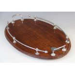 An early 20th century mahogany gallery drinks tray, of oval form with white metal handles, with