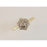 A diamond floral cluster 18ct gold ring, comprising seven single cut diamonds illusion set in