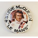 A vintage circular Steve McQueen 'Le Mans' enamel sign, mid 20th century, made to promote the