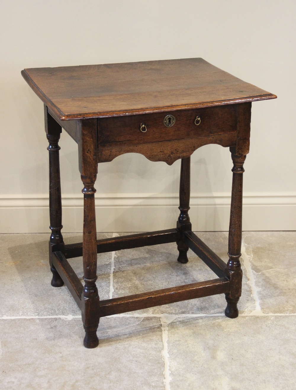 An 18th century oak side table, of cottage proportions, the rectangular moulded top raised upon ring - Image 2 of 2