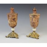 A pair of Grand Tour turned stone urns, 19th century, the bodies possibly red serpentine of