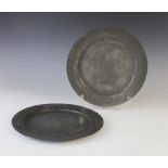 Two continental pewter chargers, 19th century, each with scroll and foliate border around a