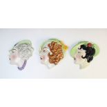 Three Art Deco wall masks by Cope & Co, each modelled as a young lady in profile with green hat,