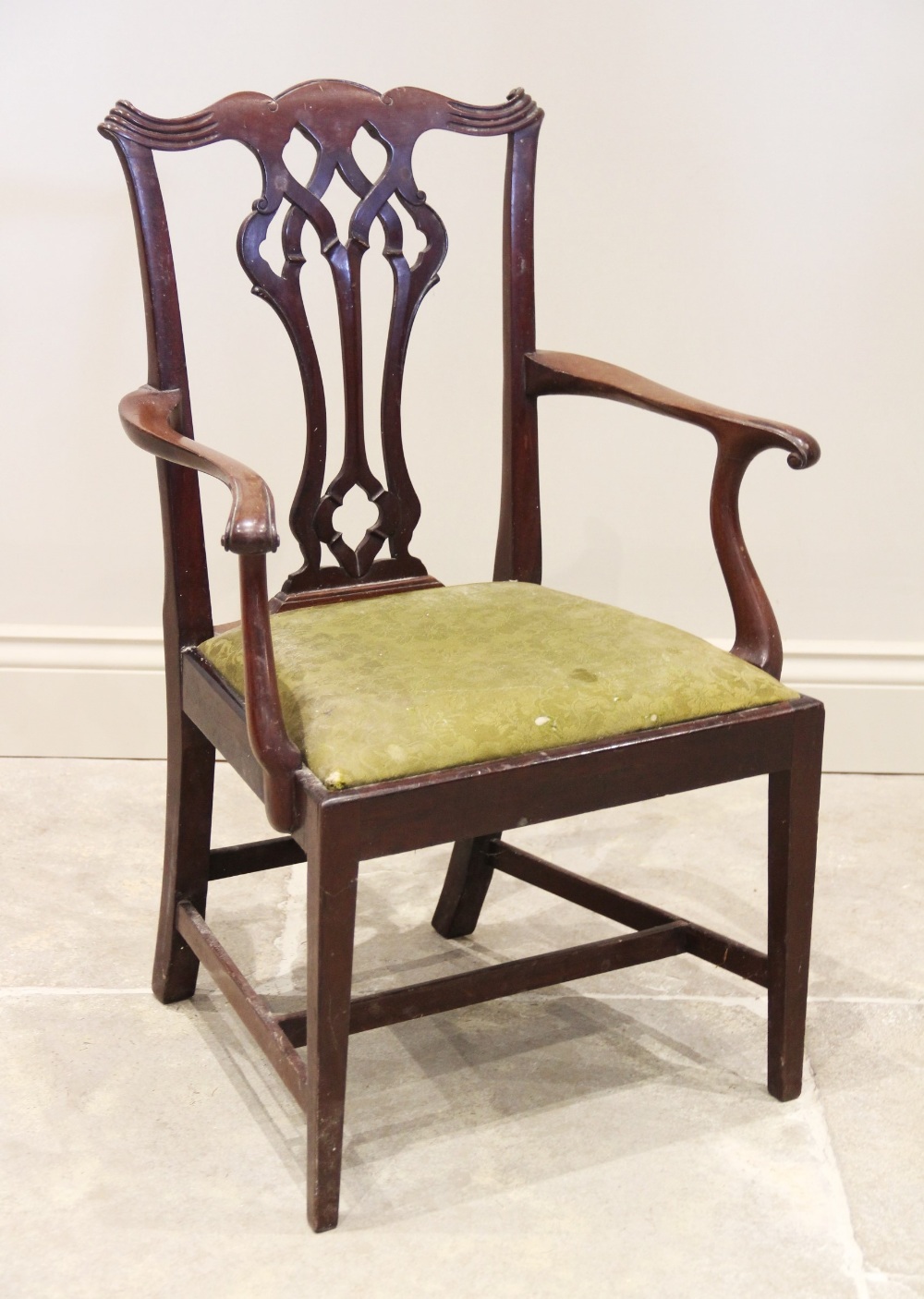 A 19th century Chippendale style mahogany child's elbow chair, the interlaced splat back extending
