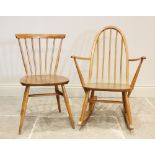 An Ercol blonde elm and beech wood stick back rocking chair, the hoop back above a shaped seat