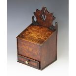 An 18th century oak candle box, the shaped fret work back centred with a heart shaped aperture,