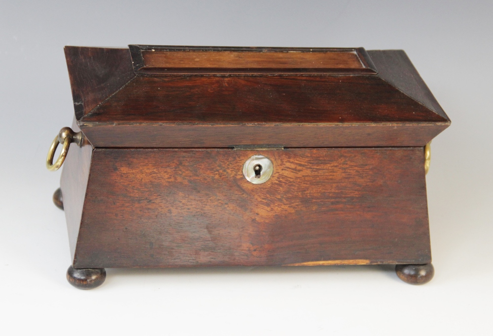 A William IV walnut tea caddy, early 19th century, of sarcophagus form on bun feet with drop ring