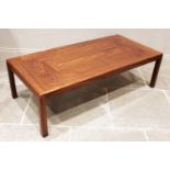 A mid century rosewood coffee table, probably Indian rosewood, the rectangular top on rounded legs