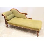 A Victorian mahogany framed chaise longue, the shaped padded back extending to swept and scrolled