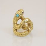 A continental 18ct gold turquoise and ruby set snake ring, the coiled body with engraved decoration,
