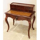 A Louis XV style walnut bonheur du jour, late 19th/early 20th century, the raised back with an
