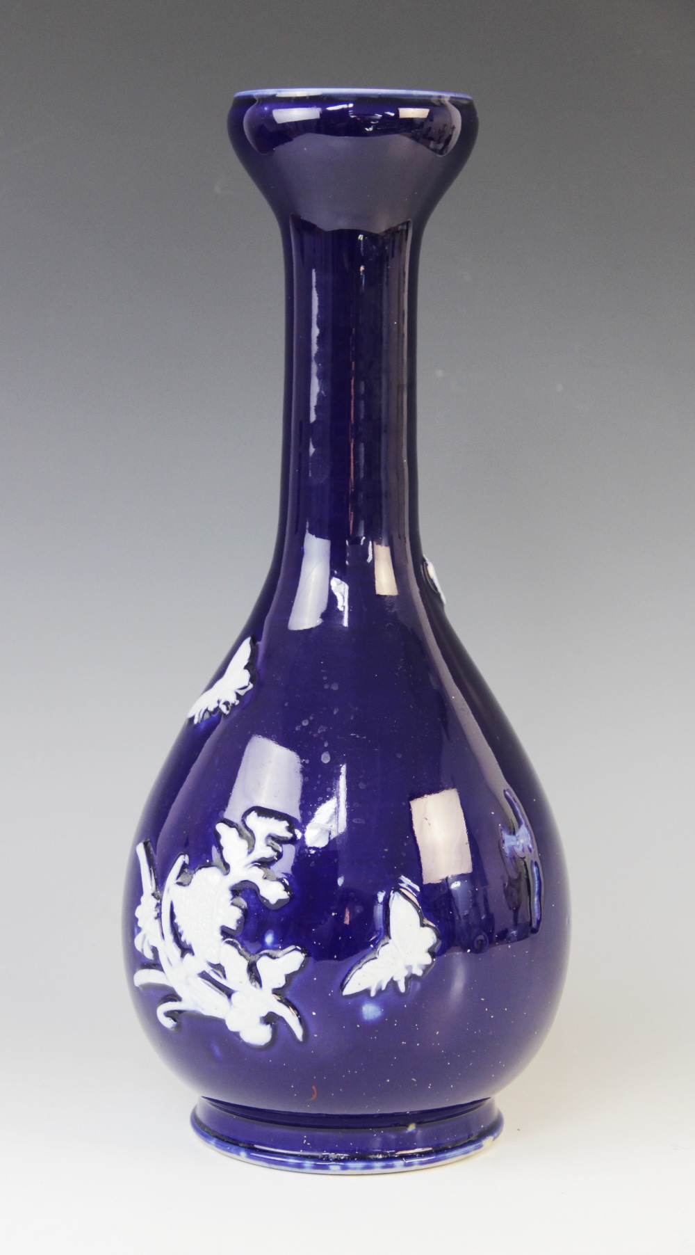 A Japanese blue and white vase, 19th/20th century, the garlic neck shaped vase decorated in white