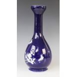 A Japanese blue and white vase, 19th/20th century, the garlic neck shaped vase decorated in white