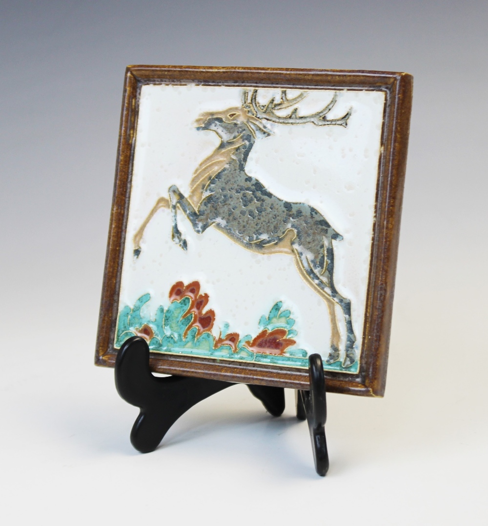 A Porceleyne Fles Royal Delft cloisonné tile depicting a leaping stag, early 20th century, impressed