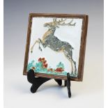 A Porceleyne Fles Royal Delft cloisonné tile depicting a leaping stag, early 20th century, impressed