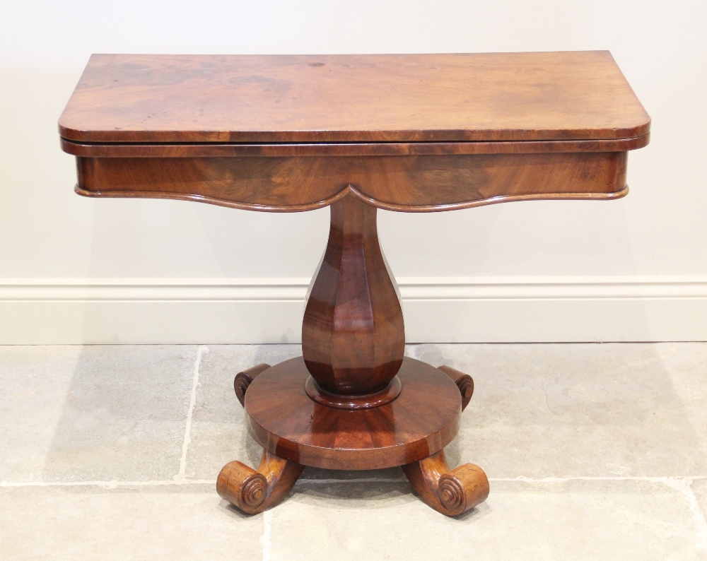 A William IV mahogany pedestal tea table, the rectangular hinged top with rounded front corners,