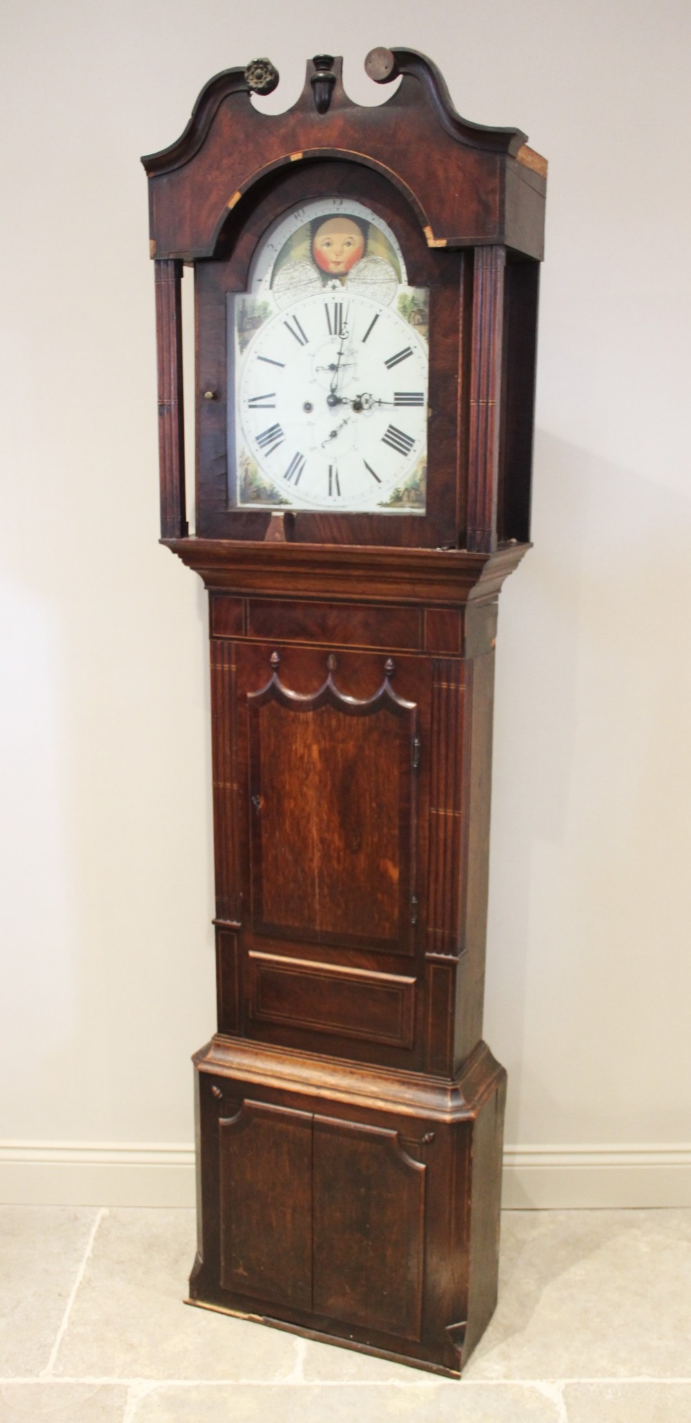 A large George IV oak and mahogany cross banded eight day longcase clock, the 36cm painted break